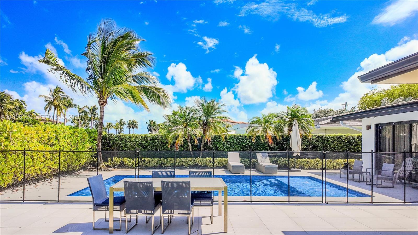 12855 Maple Road North Miami, FL 33181 - Photo 44 of 51 a view of a patio with swimming pool table and chairs