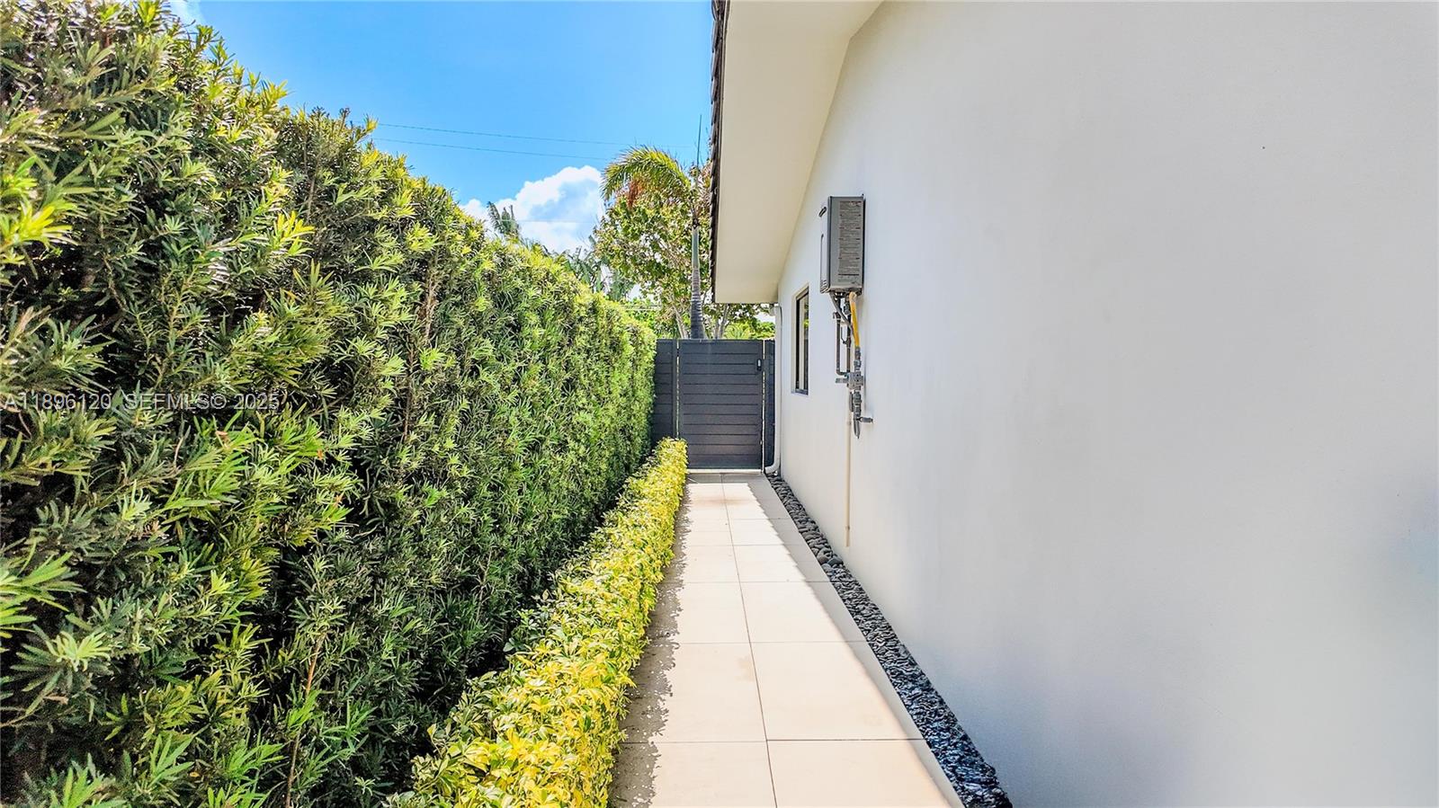 12855 Maple Road North Miami, FL 33181 - Photo 47 of 51 a view of a pathway both side of a house