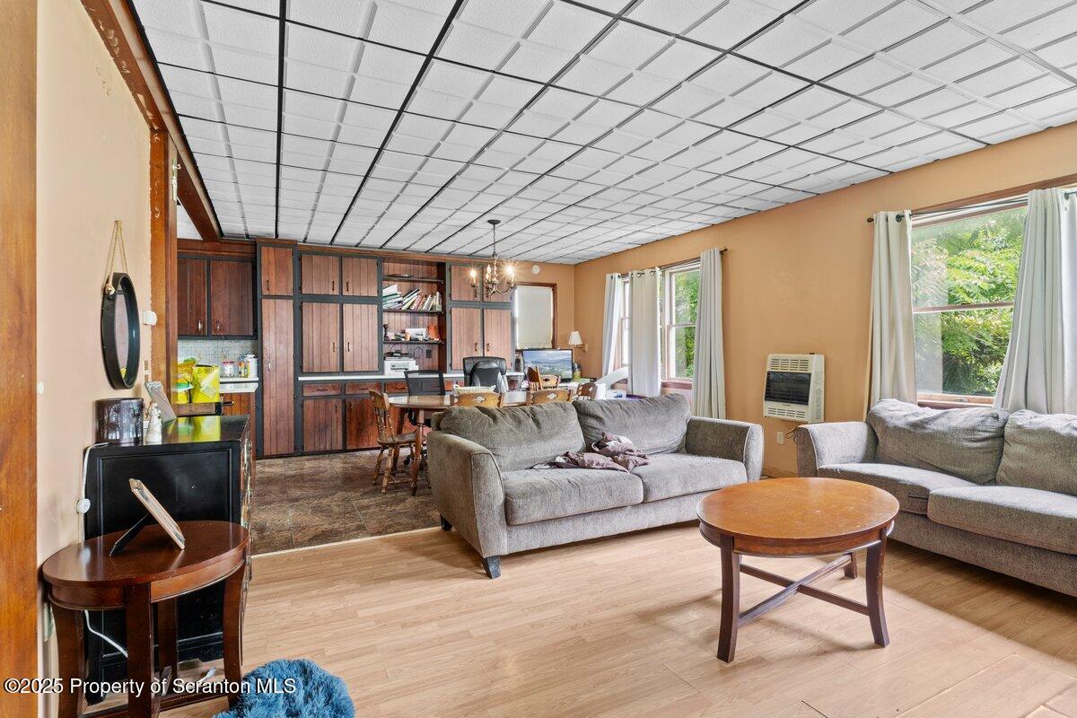 1411 Watson Street Scranton, PA 18504 - Photo 15 of 38 a living room with furniture a fireplace and a table