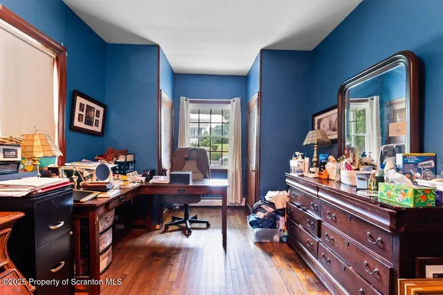 a room with wooden floor and furniture