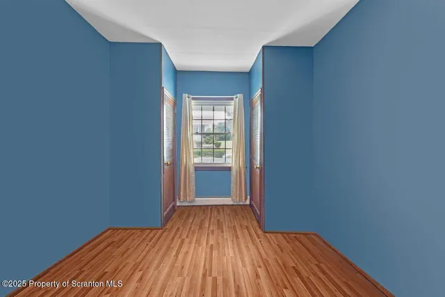 a view of a room with wooden floor