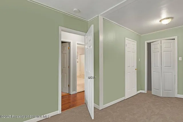 an empty room with closet and a bathroom