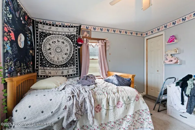 a bedroom with bed and a mirror