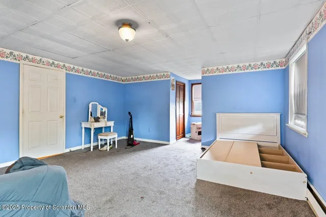 a bedroom with a bed and a chair