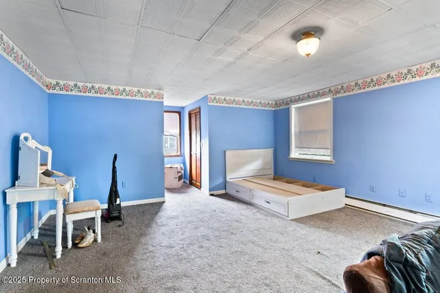 a bedroom with furniture and a lamp