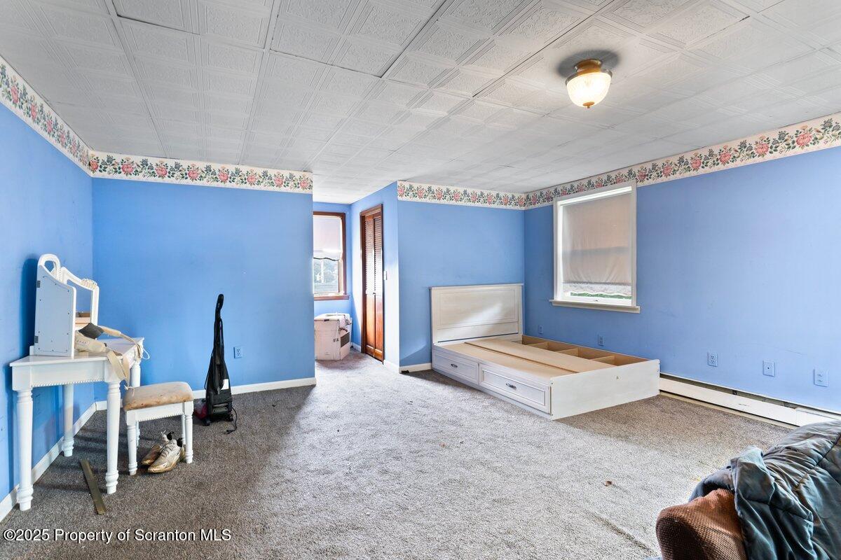 1411 Watson Street Scranton, PA 18504 - Photo 31 of 38 a bedroom with furniture and a lamp