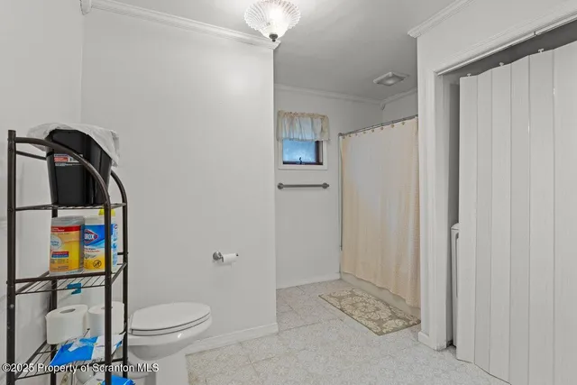 a bathroom with a toilet sink and shower