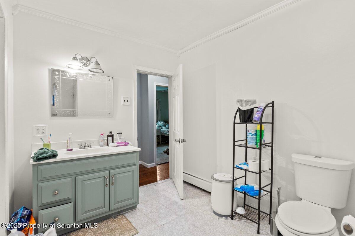1411 Watson Street Scranton, PA 18504 - Photo 35 of 38 a bathroom with a toilet sink and mirror