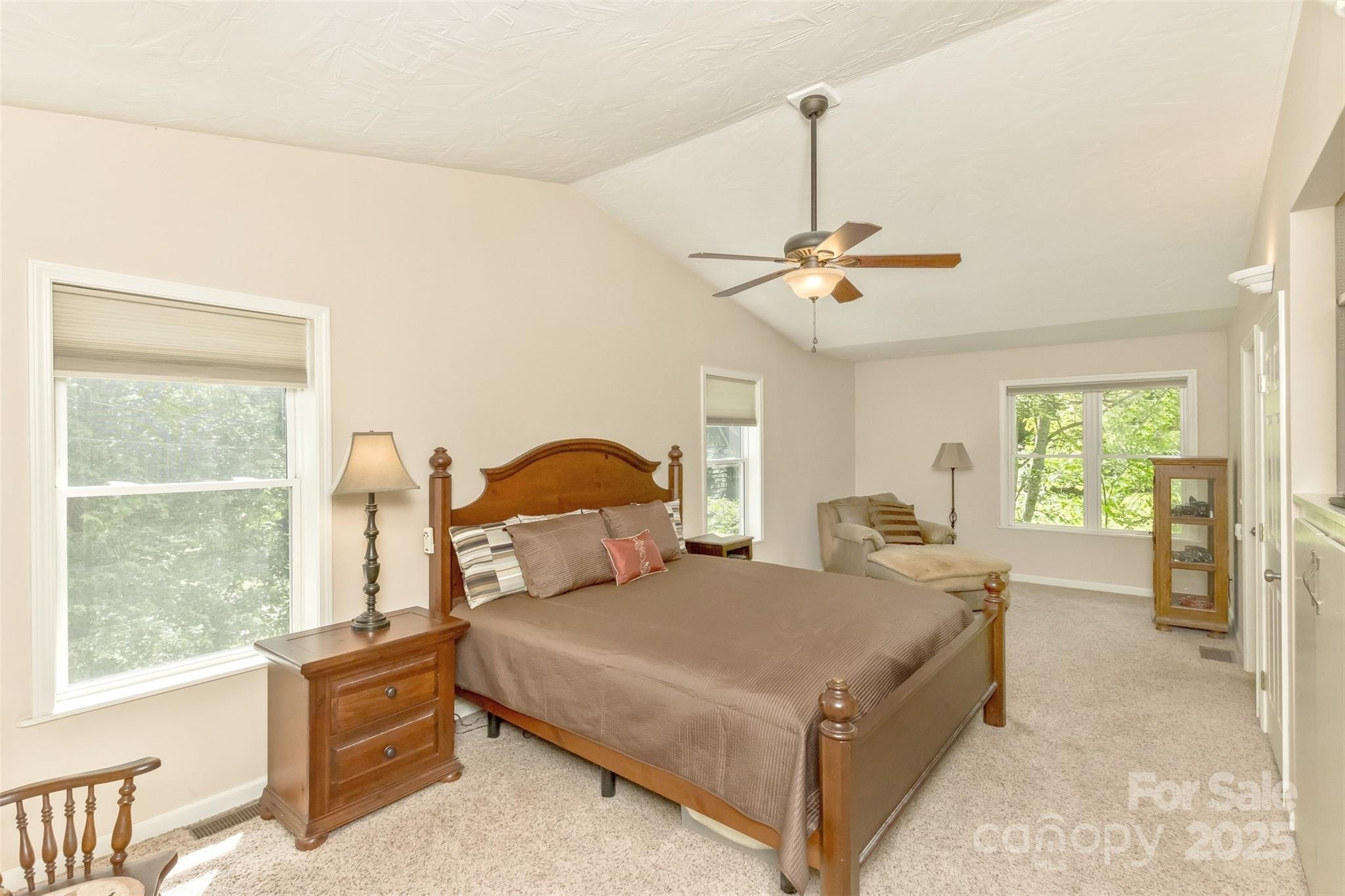 15 Beaverdam Knoll Road Asheville, NC 28804 - Photo 15 of 39 a bedroom with a large bed and a chandelier