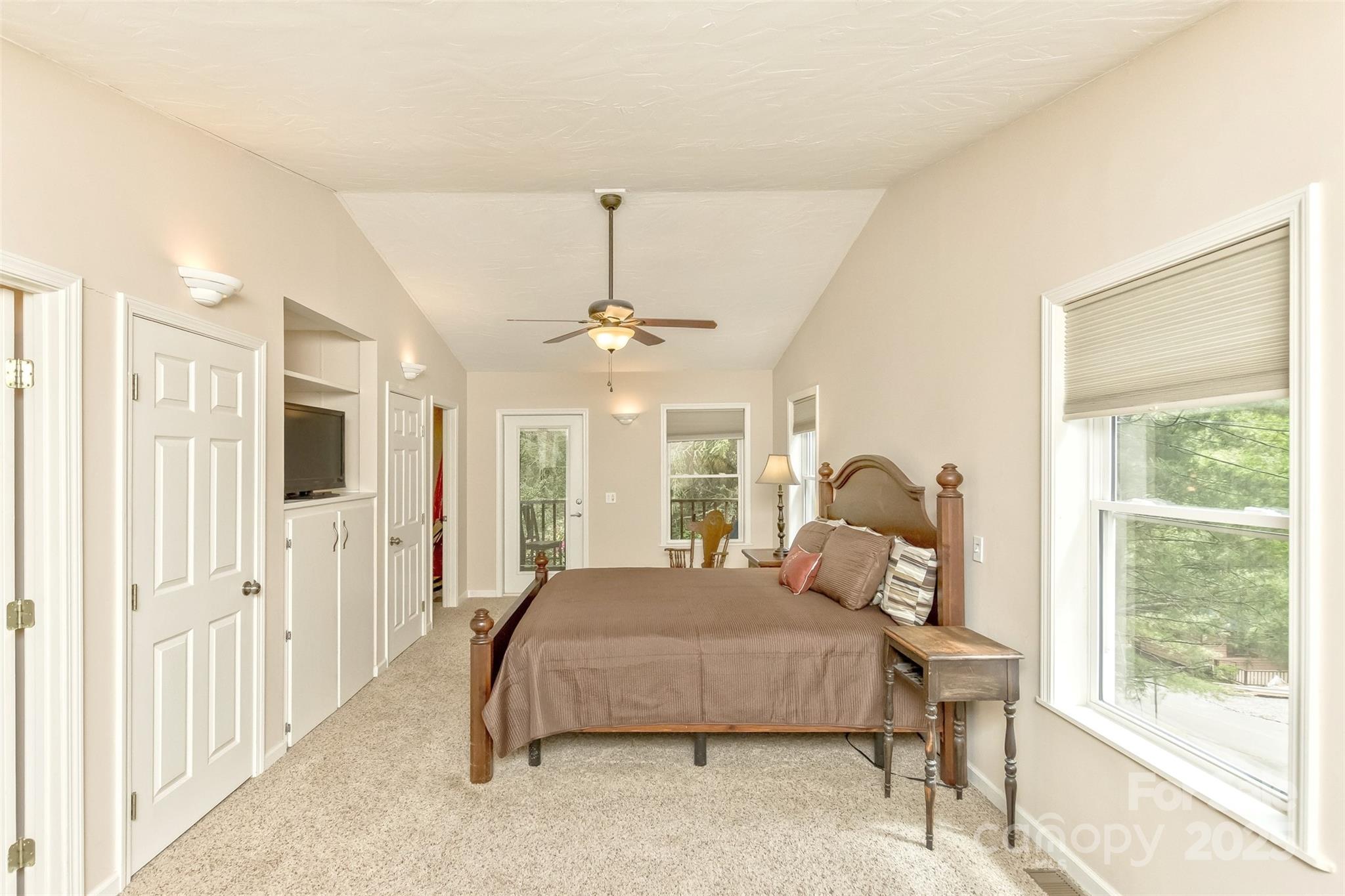 15 Beaverdam Knoll Road Asheville, NC 28804 - Photo 16 of 39 a bedroom with a bed mirror and window