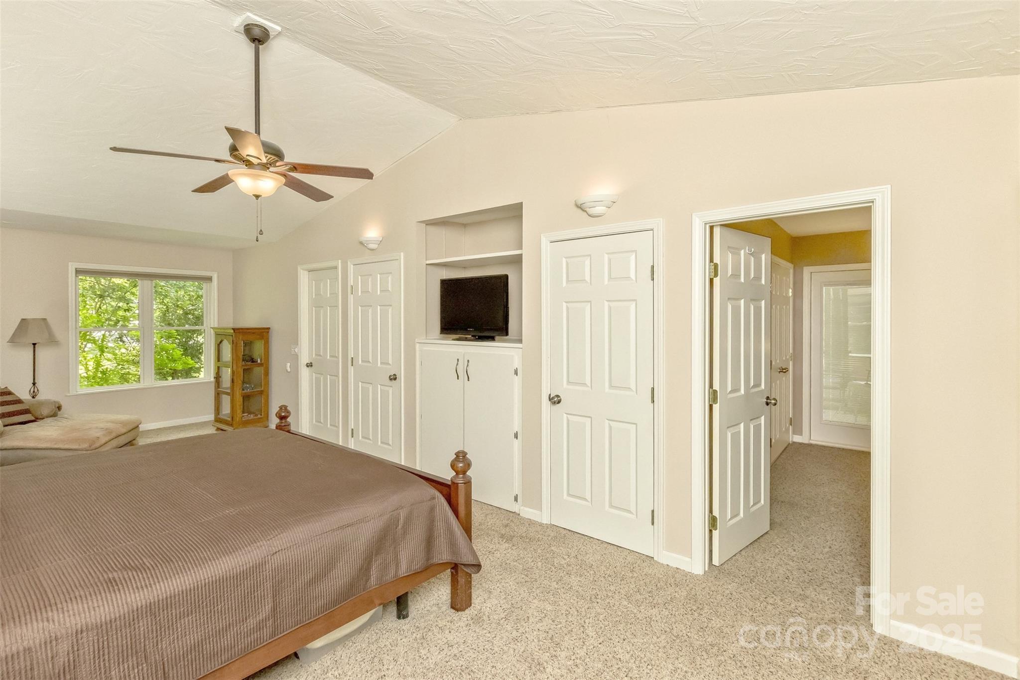 15 Beaverdam Knoll Road Asheville, NC 28804 - Photo 17 of 39 a bedroom with a bed ceiling fan and a wooden floor
