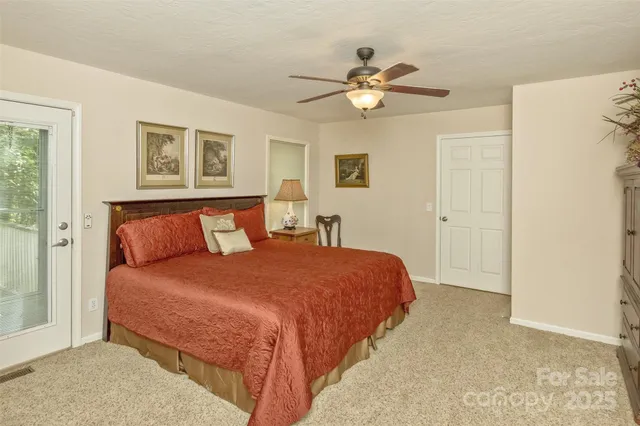 a bedroom with a large bed and a chandelier