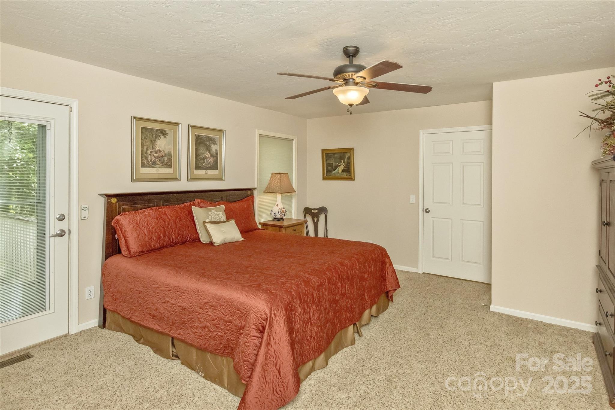 15 Beaverdam Knoll Road Asheville, NC 28804 - Photo 22 of 39 a bedroom with a large bed and a chandelier