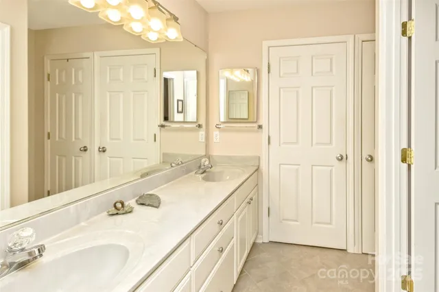a bathroom with a double vanity sink and a mirror