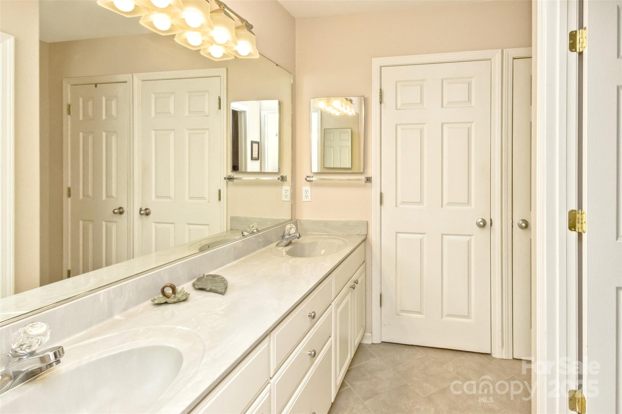 15 Beaverdam Knoll Road Asheville, NC 28804 - Photo 24 of 39 a bathroom with a double vanity sink and a mirror