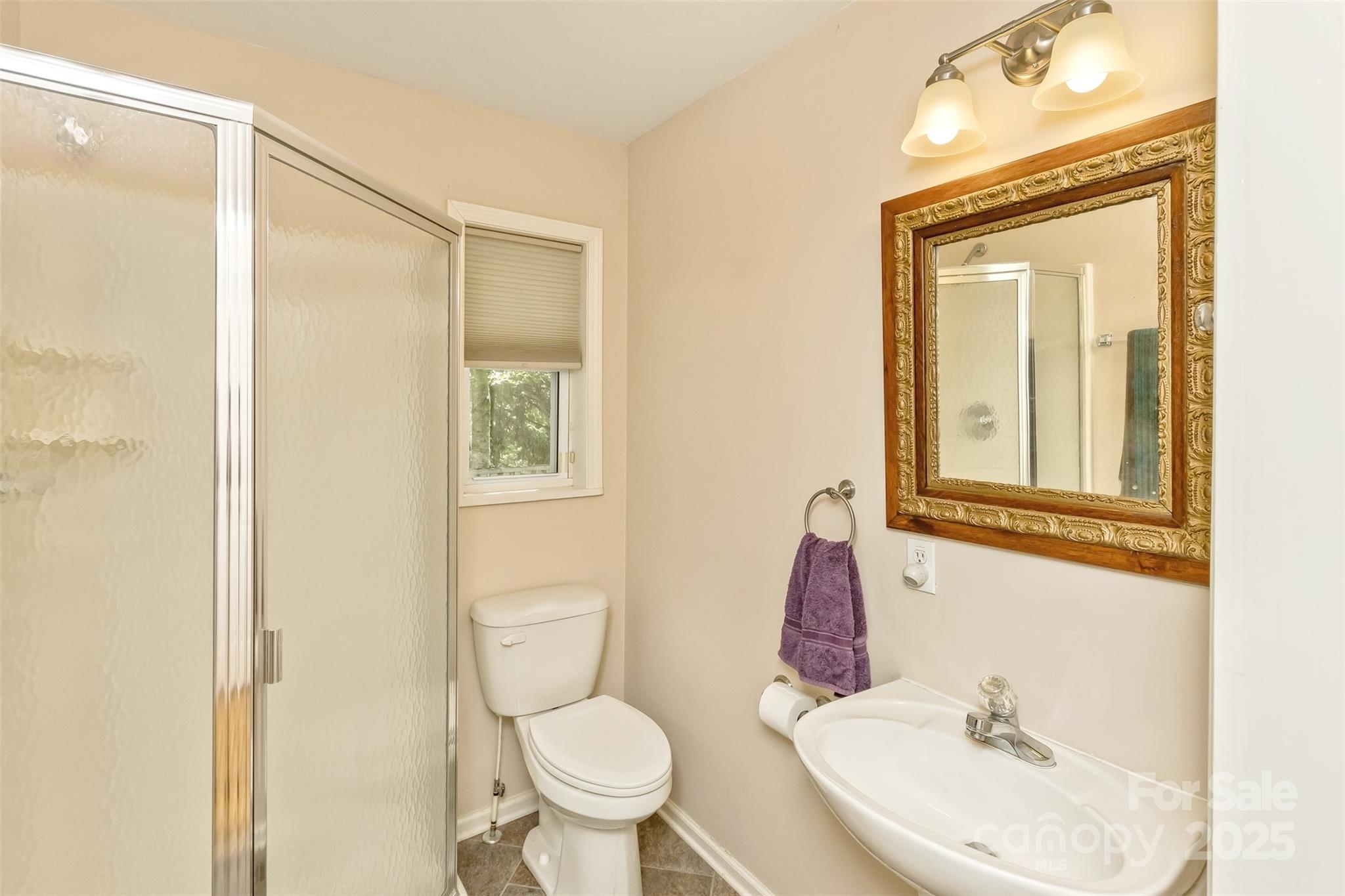 15 Beaverdam Knoll Road Asheville, NC 28804 - Photo 27 of 39 a bathroom with a sink toilet and shower