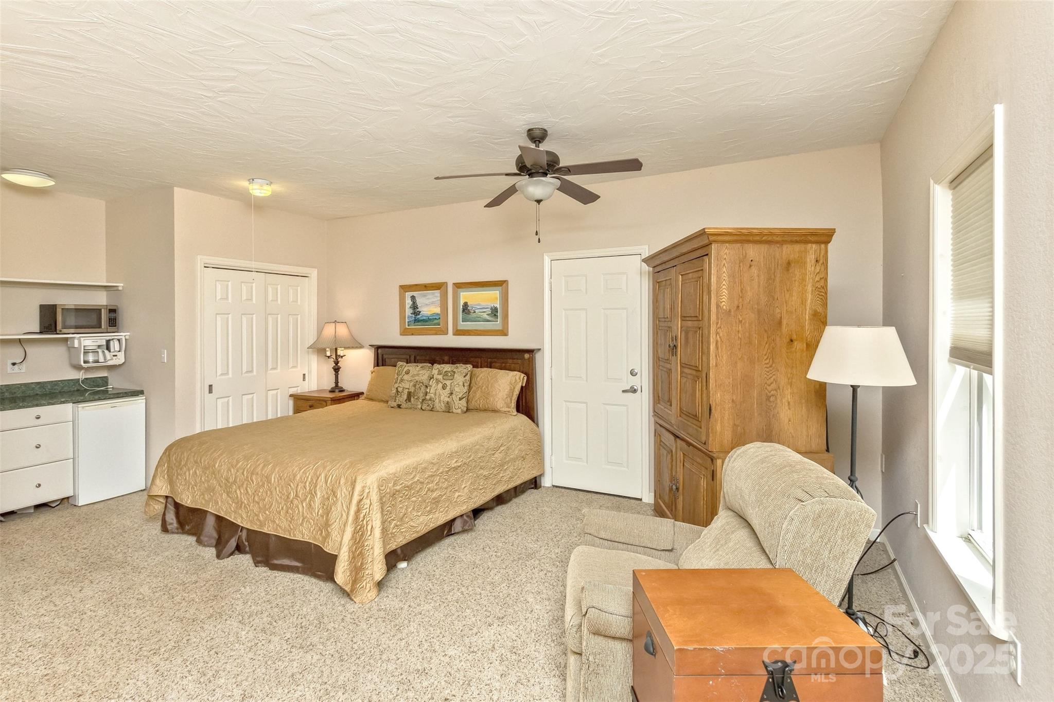 15 Beaverdam Knoll Road Asheville, NC 28804 - Photo 29 of 39 a spacious bedroom with a bed and dresser
