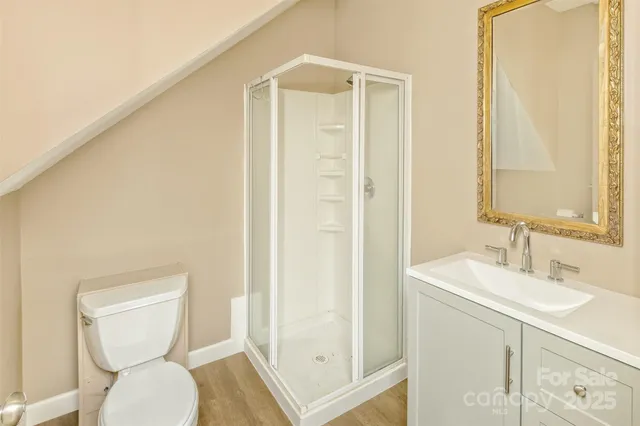 a bathroom with a toilet a sink and a mirror