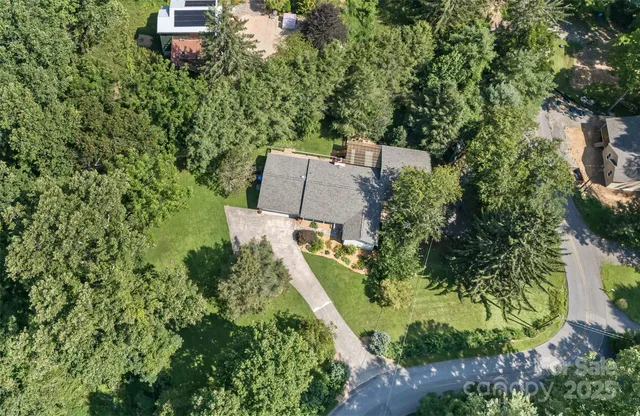 an aerial view of a house with outdoor space and street view