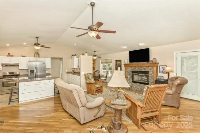 a living room with fireplace furniture and a flat screen tv