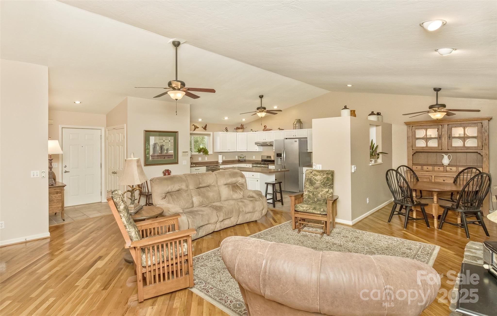 15 Beaverdam Knoll Road Asheville, NC 28804 - Photo 6 of 39 a living room with furniture a dining table and a chandelier