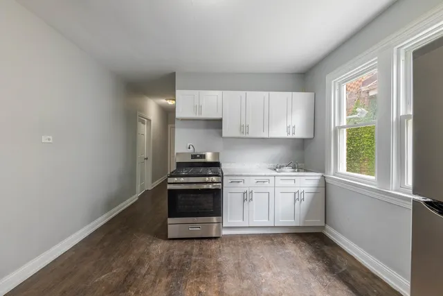 a kitchen with stainless steel appliances granite countertop a stove and a sink