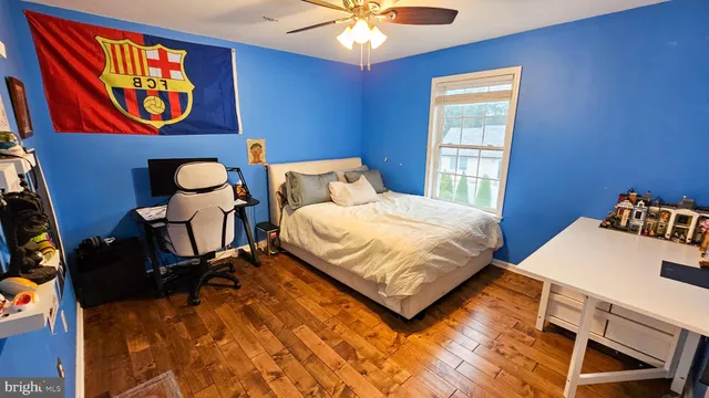 a bedroom with 2 bed and a chandelier