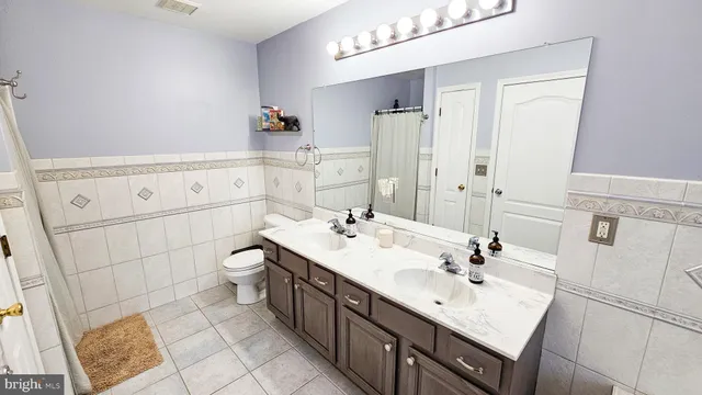 a bathroom with a sink double vanity and a mirror