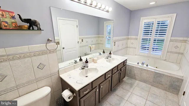 a bathroom with a sink a toilet and bathtub