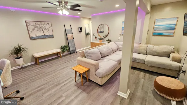 a living room with furniture and wooden floor