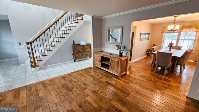 a living room with fireplace furniture and a dining table