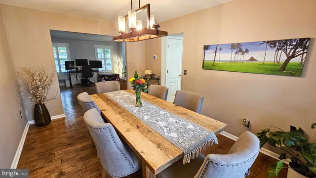 a view of a dining room with furniture and a chandelier