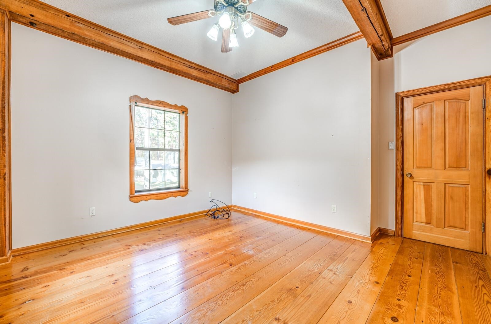 4626 Billy Maher Road Memphis, TN 38135 - Photo 27 of 35 an empty room with wooden floor chandelier fan and windows