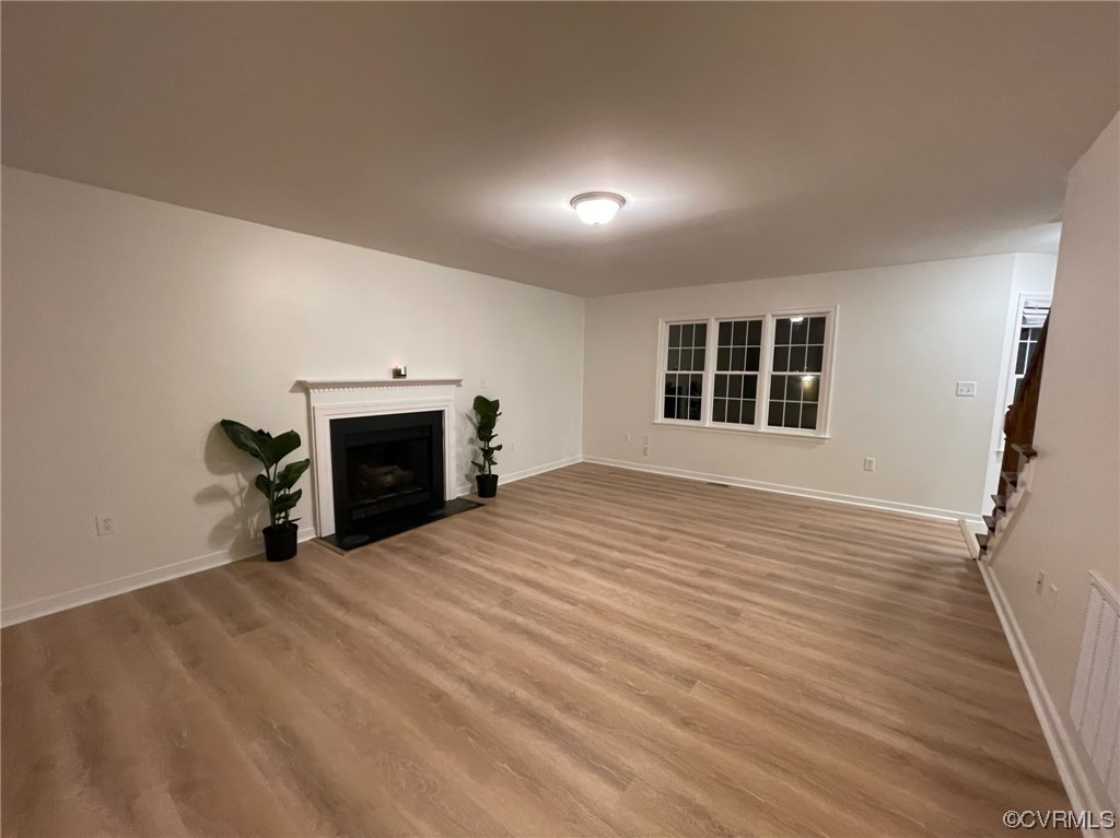 8130 Preakness Court Midlothian, VA 23112 - Photo 9 of 29 a big room with wooden floor and a fireplace