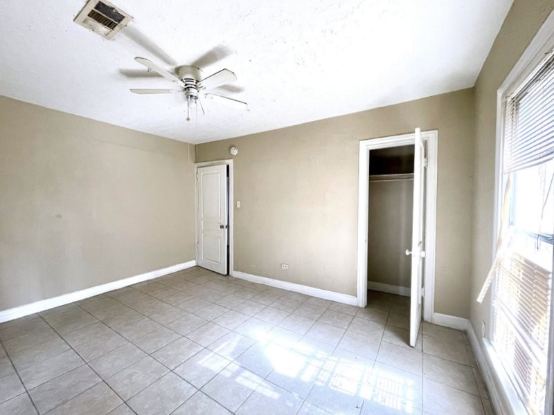 2814 Elysian Street Houston, TX 77009 - Photo 10 of 10 an empty room with windows and fan