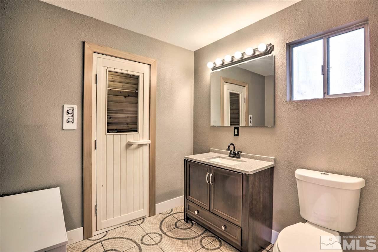 321 Barton Drive Stateline, NV 89449 - Photo 13 of 23 a bathroom with a toilet sink and mirror