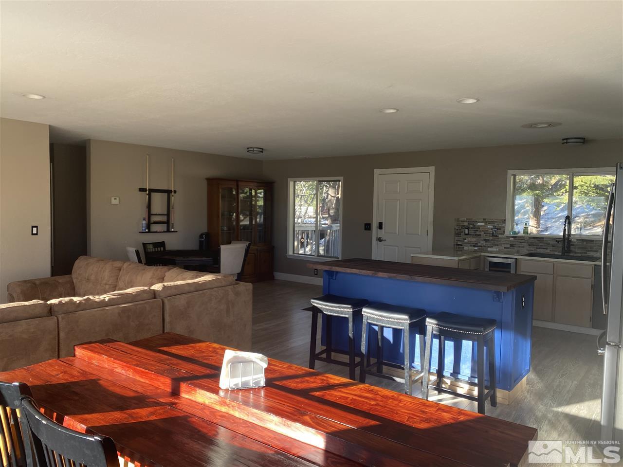 321 Barton Drive Stateline, NV 89449 - Photo 4 of 23 a kitchen with stainless steel appliances kitchen island granite countertop a table chairs in it and a large window