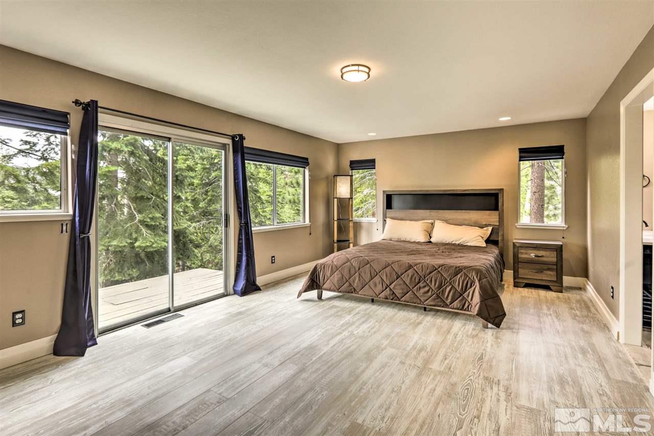 321 Barton Drive Stateline, NV 89449 - Photo 9 of 23 a bedroom with a large bed and a large window