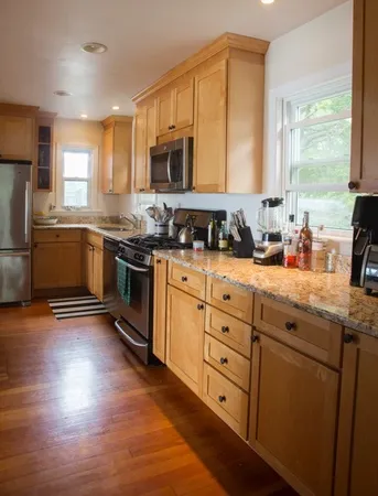 a kitchen with stainless steel appliances granite countertop a sink stove and refrigerator