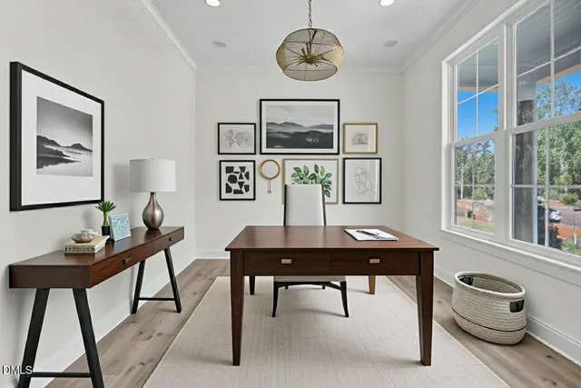 a kitchen with stainless steel appliances a sink a stove a refrigerator cabinets and a window