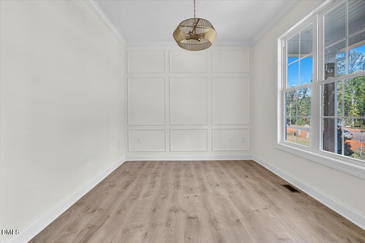 12845 Mallard Rock Road Zebulon, NC 27597 - Photo 13 of 63 a view of room with window and wooden floor