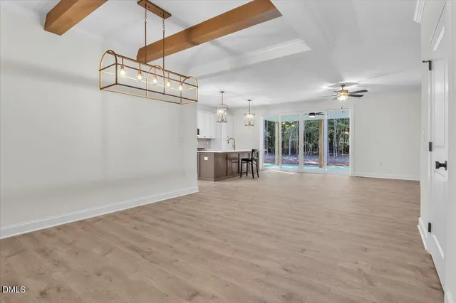 a kitchen with stainless steel appliances granite countertop a sink a stove and a wooden floors