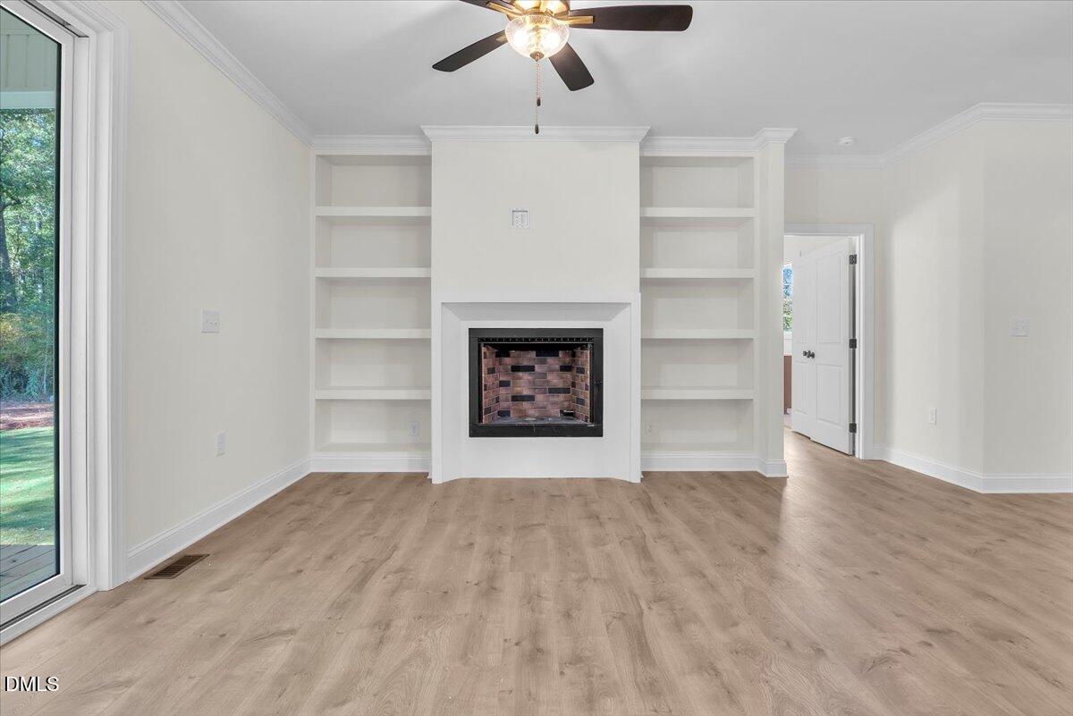 12845 Mallard Rock Road Zebulon, NC 27597 - Photo 23 of 63 a view of an empty room with a ceiling fan and window