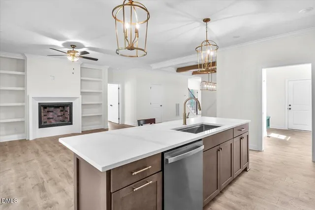 an empty room with chandelier fan