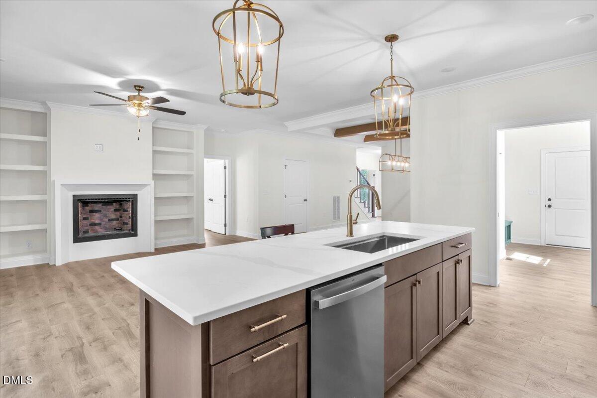 12845 Mallard Rock Road Zebulon, NC 27597 - Photo 24 of 63 a kitchen with sink cabinets and chandelier