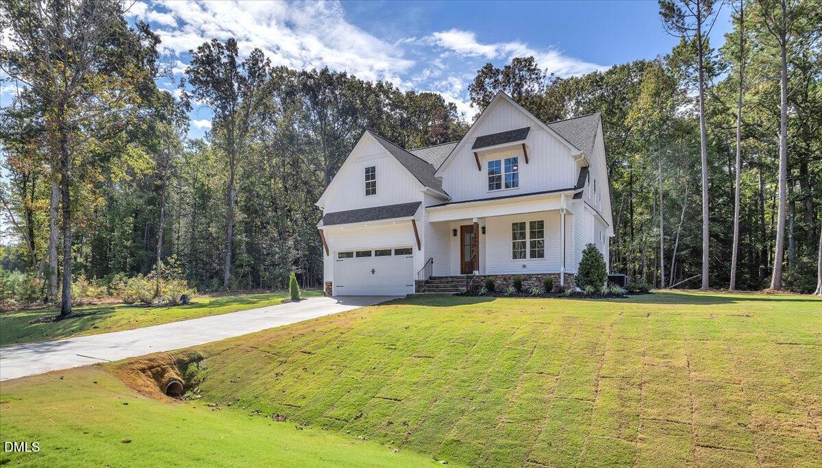12845 Mallard Rock Road Zebulon, NC 27597 - Photo 3 of 63 a front view of a house with swimming pool having outdoor seating