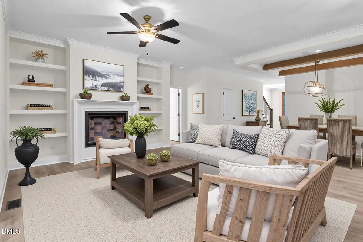 12845 Mallard Rock Road Zebulon, NC 27597 - Photo 32 of 63 a living room with furniture a fireplace and a large window