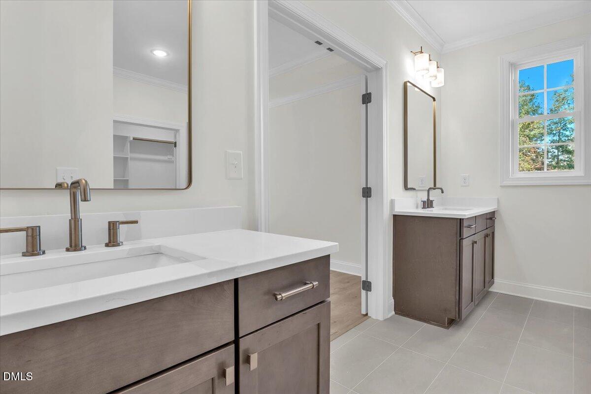 12845 Mallard Rock Road Zebulon, NC 27597 - Photo 40 of 63 a bathroom with a sink vanity and a mirror