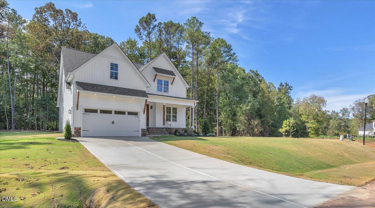 12845 Mallard Rock Road Zebulon, NC 27597 - Photo 4 of 63 a front view of a house with a yard