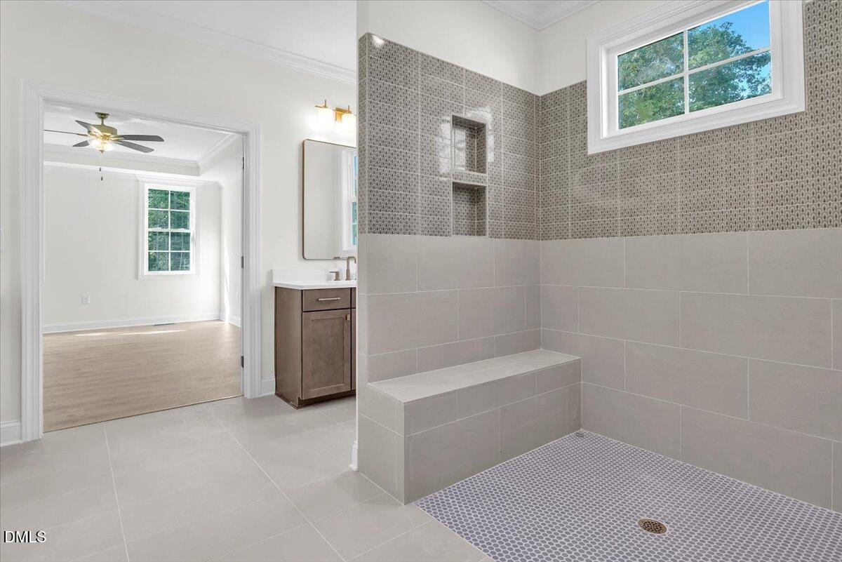 12845 Mallard Rock Road Zebulon, NC 27597 - Photo 43 of 63 a bathroom with a bathtub sink and mirror